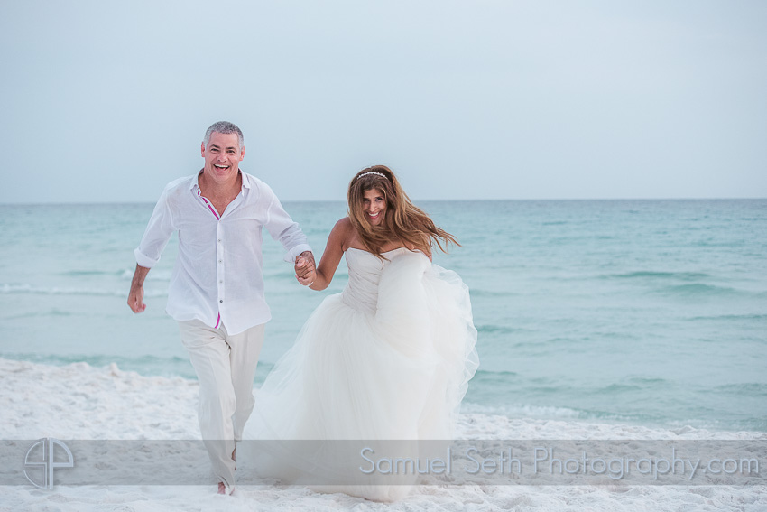 bride and groom running on beach wedding photography